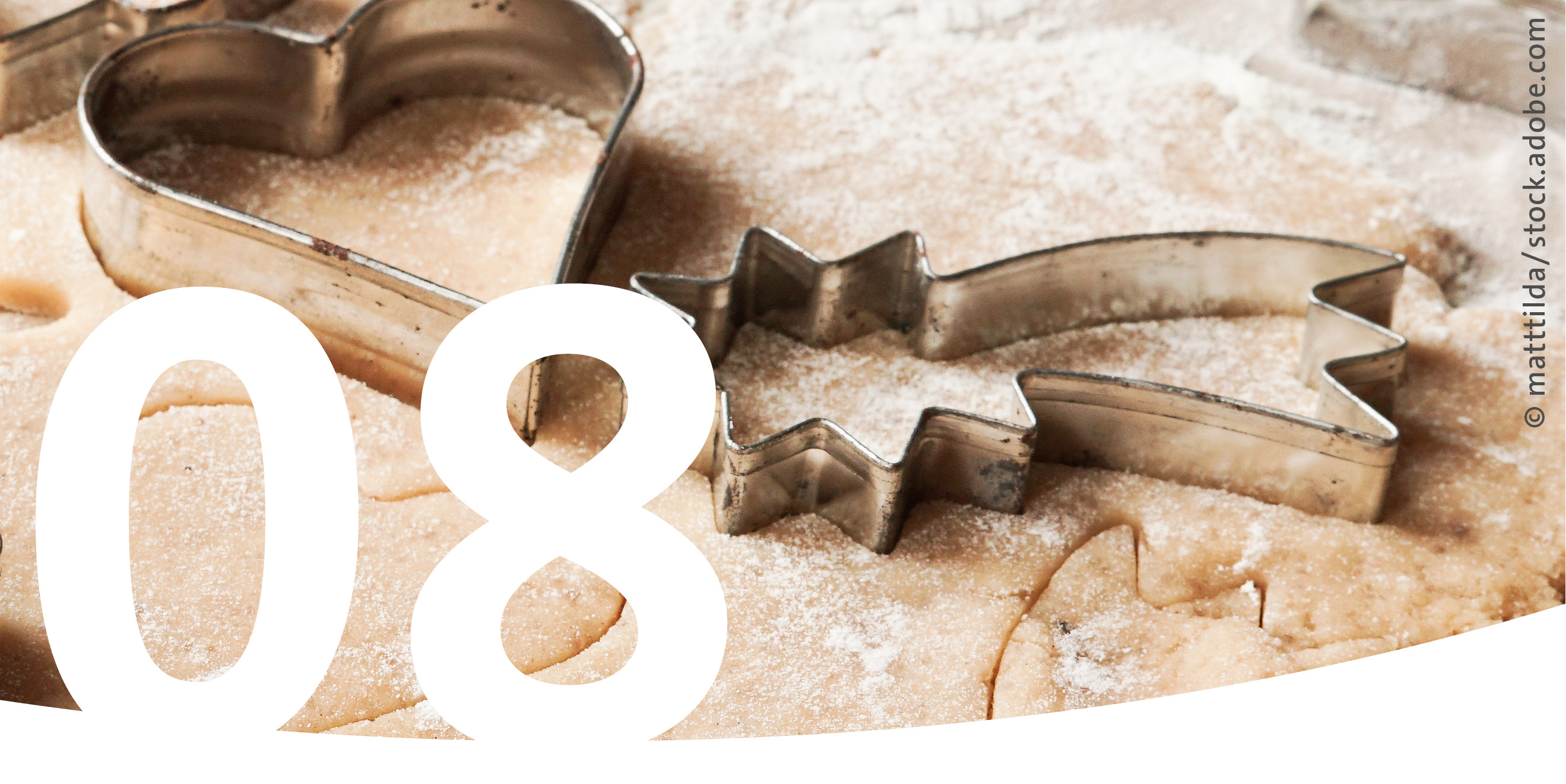 Cookie cutters, cookie dough, and the number 8 in the foreground.