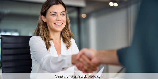 Woman shaking hands with her interviewer at a job interview.