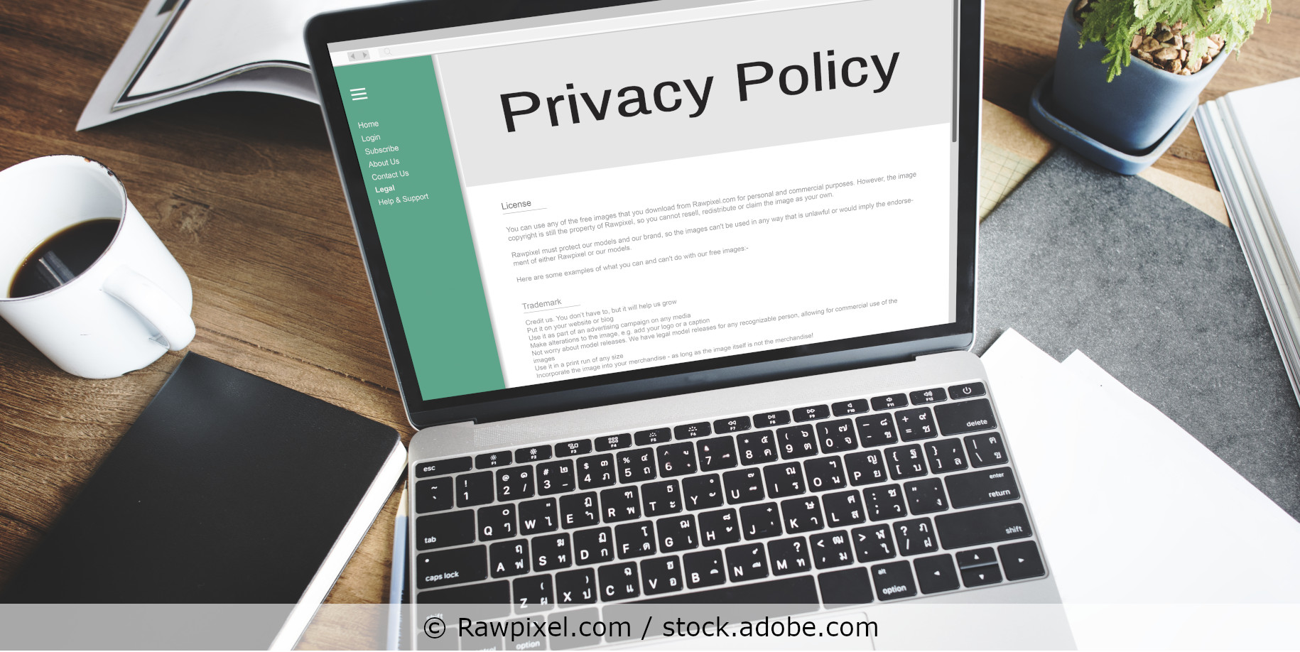 Laptop on a desk displaying a privacy policy on its screen.