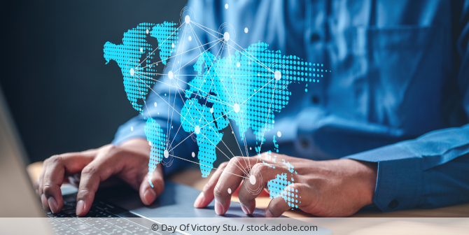 Person working on a laptop, world map symbolizing cross-border data transfers.