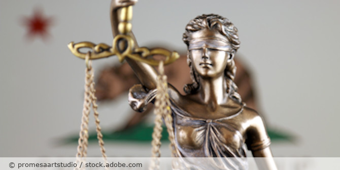 Lady Justice figure with the California flag in the background.