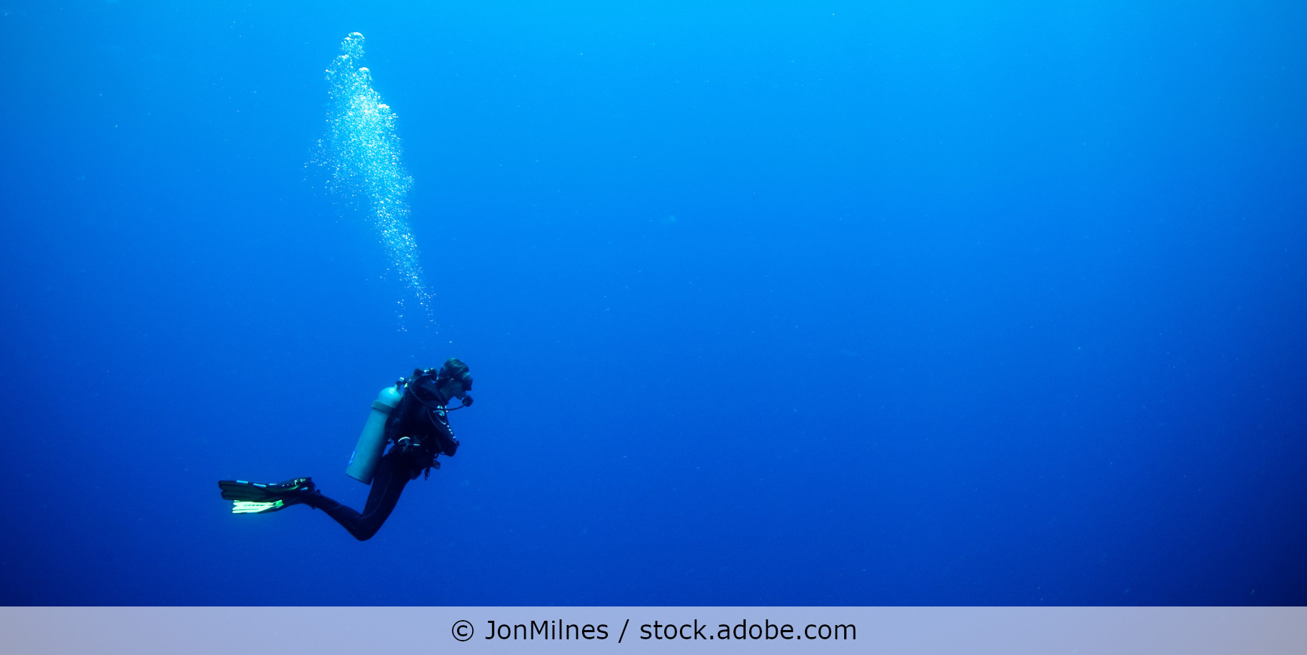 scuba diver in deep blue water